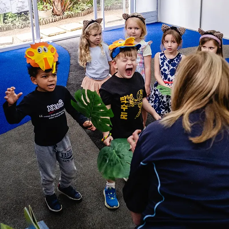 Through drama, storytelling and imaginative play, children build confidence, communication skills and creativity while learning to express themselves in a fun and engaging way. Children participating in a drama and movement activity, using costumes, props and imaginative play during a classroom performance.